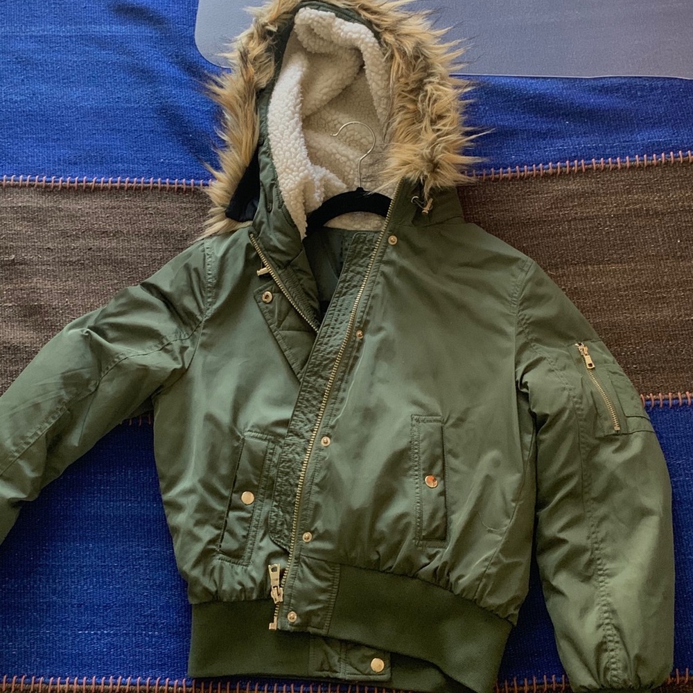 A Camo Green jacket with a Fuzzy hood